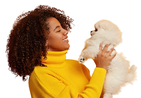 Woman smiling with a white puppy