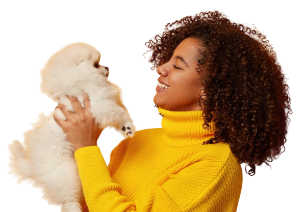 Woman holding a white puppy